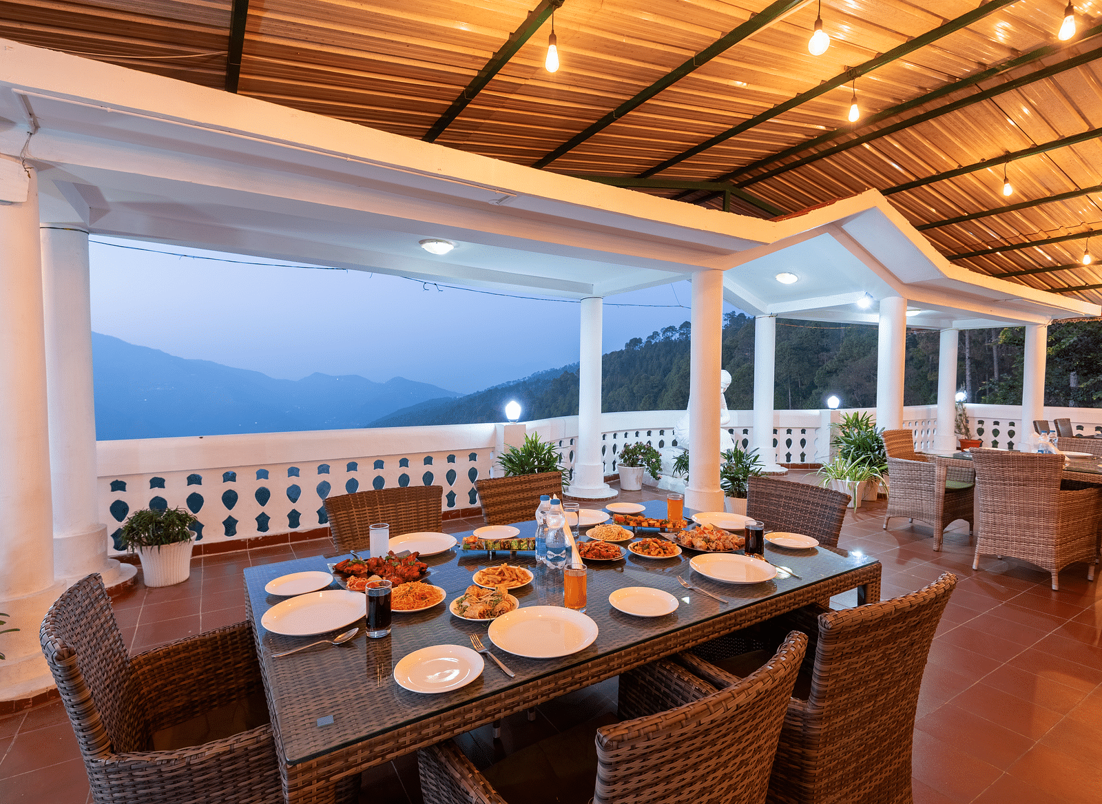 A scenic dining area at DLS Tehri Club Resort with a breathtaking view of the mountains.
